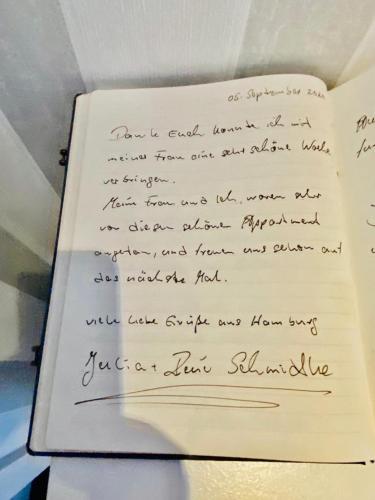 a handwritten letter on top of a book at Gästehaus Ehringhausen 63 (Anno 1719) in Remscheid