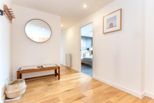 a living room with a table and a mirror at SECC Hydro Executive 7 Apartment in Glasgow
