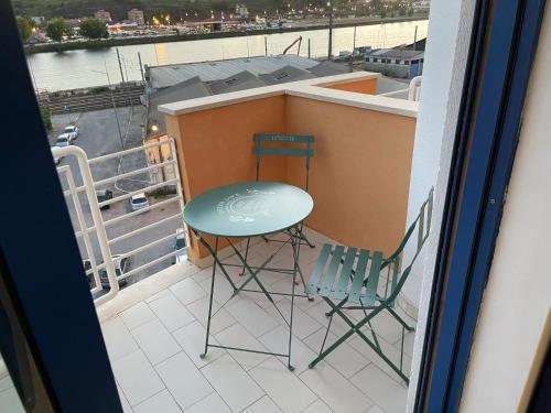 a balcony with two chairs and a table and a table at Miguel Torga River in Coimbra