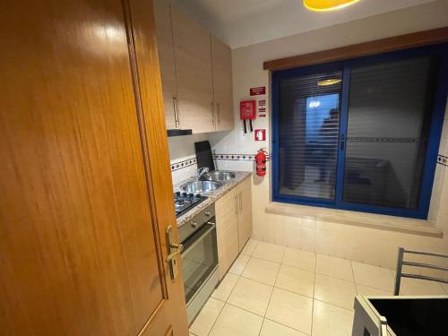 a small kitchen with a sink and a stove at Miguel Torga River in Coimbra