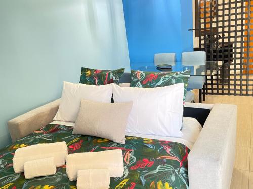 a bed with pillows on it in a room at Miguel Torga River in Coimbra