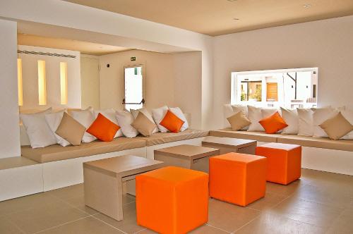 a living room with a couch with orange and white pillows at BQ Amfora Beach - Adults Only in Can Pastilla