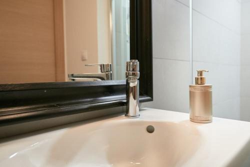 a bathroom sink with a faucet and a mirror at Sea & the City in Dubrovnik