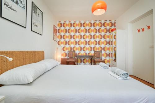 a bedroom with a large white bed and a wall at Sea & the City in Dubrovnik