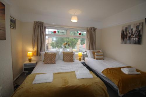 a bedroom with two beds and a window at Brookdale House in Skegby