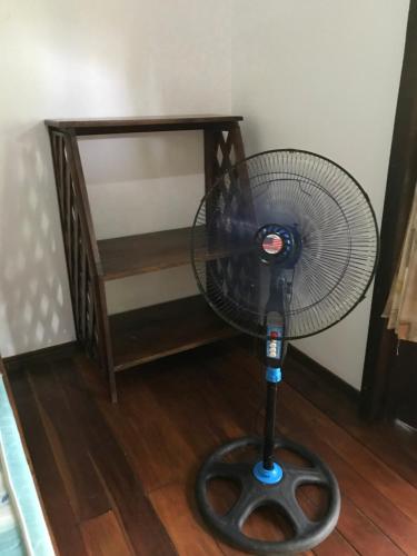 a fan is sitting on the floor next to a table at FLOR DE PARAISO BUNGALOWS in Montezuma