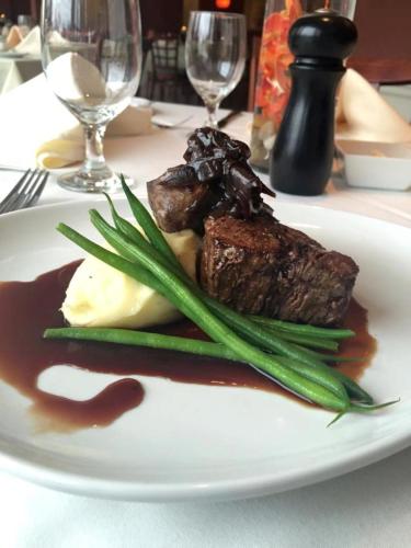a plate of food with meat and vegetables on a table at The New London Inn in New London