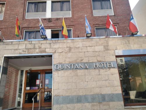 a building with flags on top of it at Quintana Hotel in San Luis