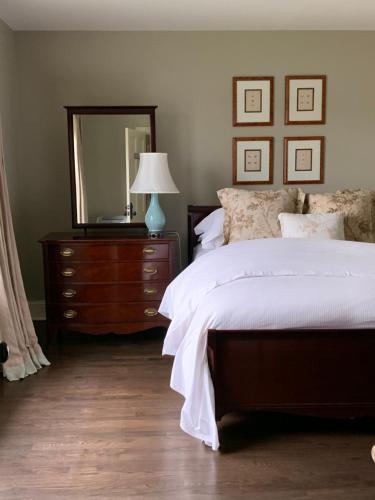 a bedroom with a bed and a dresser with a mirror at The Pebble Bed and Breakfast in Halifax