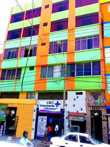 a colorful building with a car parked in front of it at Sombrero de Paja in Chiclayo