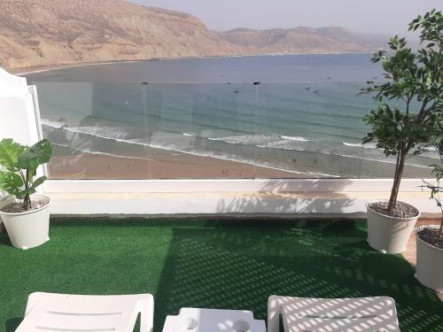 a balcony with a view of the beach and the ocean at Imsouane Magic House in Imsouane