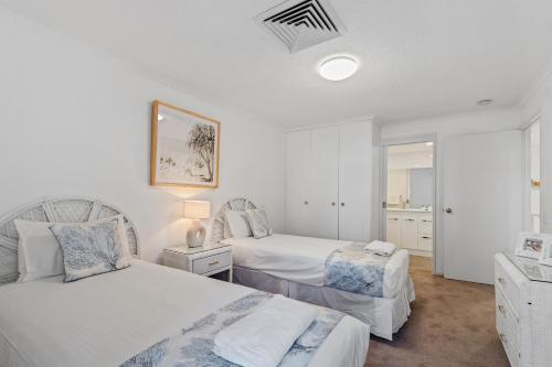Ένα ή περισσότερα κρεβάτια σε δωμάτιο στο Noosa Boutique Apartments & Elkhorn Villas