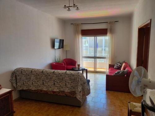 a living room with a couch and a chair at Cantinho do Zé e da Júlia in Lagos