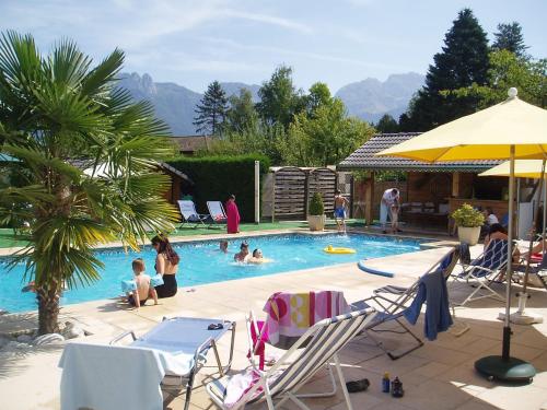 a group of people in a swimming pool at Le Conty in Saint-Jorioz