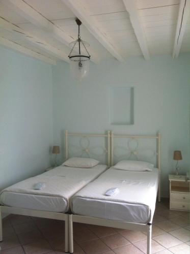 a bedroom with a bed in a blue room at Altana Boutique Hotel in Tinos Town