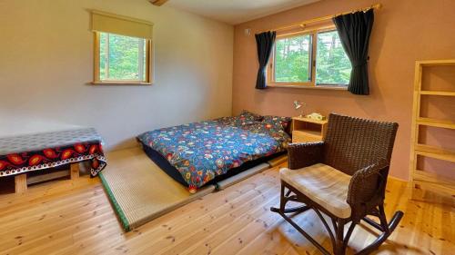 A bed or beds in a room at Pop Inn Hakuba