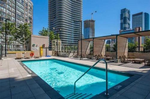 a swimming pool in a city with tall buildings at Stylish Downtown Toronto Residential Hotel in Toronto