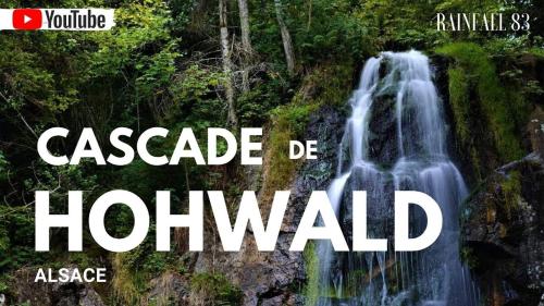 a waterfall in the jungle with the words cascade de hollywood at Au petit coin western in Le Hohwald