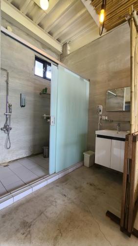 a large bathroom with a shower and a sink at 達芭凱民宿 Tabakai B&B in Xinyi