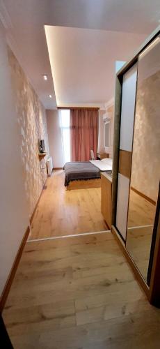 a small room with a bed and a window at Happy Stay Hotel in Kutaisi