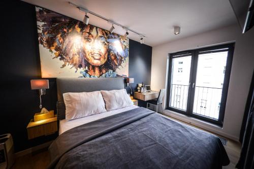 um quarto com uma cama com uma grande pintura na parede em Apartament EXCLUSIVE FYRTEL WILDA - NEW em Poznań