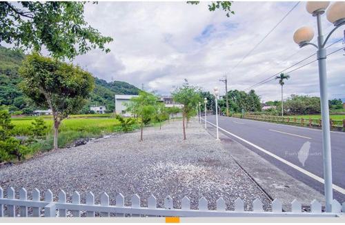 an empty street with trees on the side of the road at Blue and White Style Holiday B&B in Guanshan