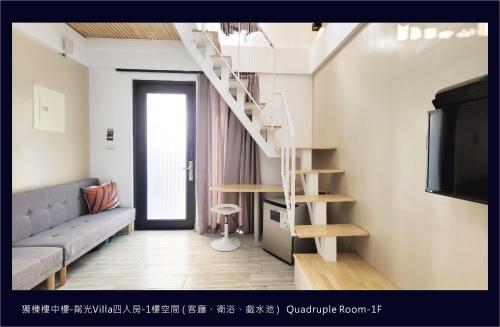 a living room with a staircase and a couch at Top Sunlight Inn in Xiaoliuqiu