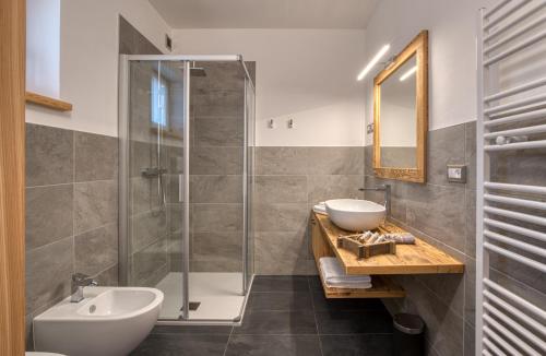 a bathroom with a sink and a shower at Agritur Maso Librar in Trento