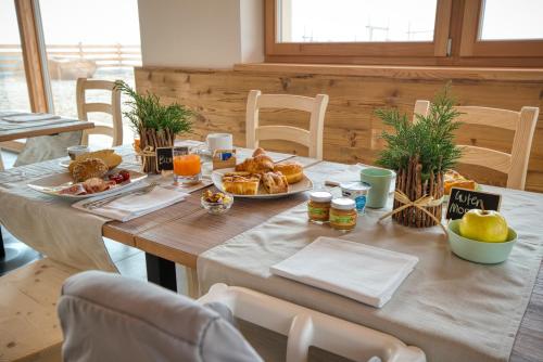 a table with breakfast foods and oranges on it at Agritur Maso Librar in Trento