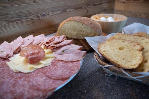 a table topped with bread and different types of food at Agritur Maso Librar in Trento