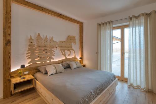 a bedroom with a bed with a horse on the wall at Agritur Maso Librar in Trento