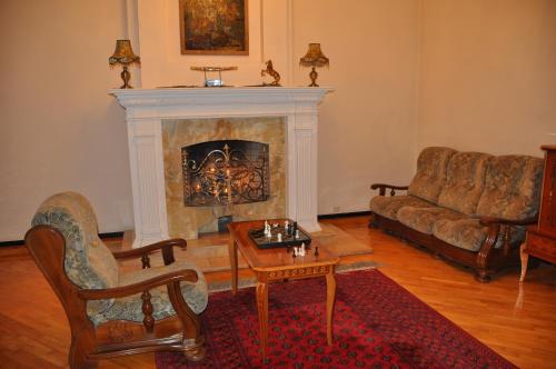 a living room with a fireplace and a couch at Hotel Samarkand Safar in Samarkand
