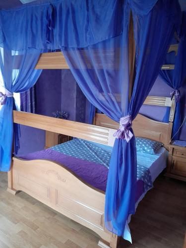 a bunk bed with blue drapes in a room at Kuća - vikendica in Kotor