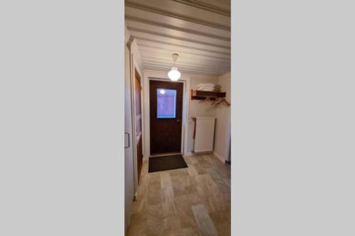 a hallway with a door leading into a room at Fully equipped house in the countryside at Knohult in Aneby
