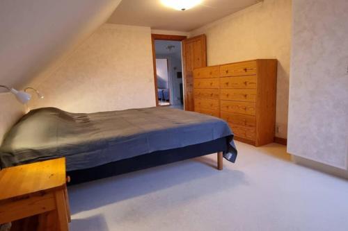 a bedroom with a bed and a wooden dresser at Fully equipped house in the countryside at Knohult in Aneby