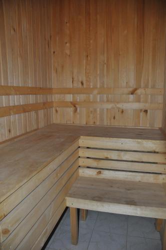 a wooden sauna with a wooden bench in it at Hotel Samarkand Safar in Samarkand