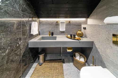 a bathroom with a sink and a toilet at Aurora Queen Resort Igloos in Saariselka