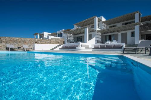 a swimming pool in front of a villa at Anemos in Parikia