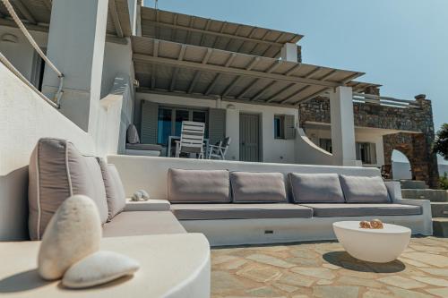 a patio with a couch and a table at Anemos in Parikia