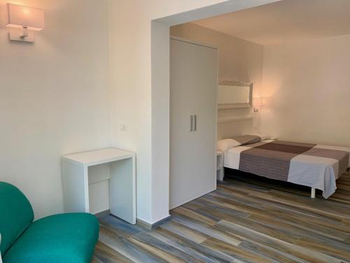 a small bedroom with a bed and a couch at Camping Village Baia Falcone in Vieste