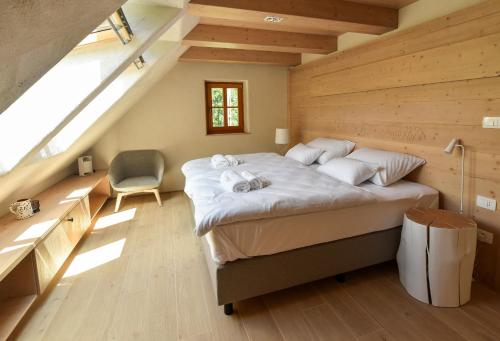 a bedroom with a large bed in a attic at JULIAN VILLAGE LEPENA in Soča