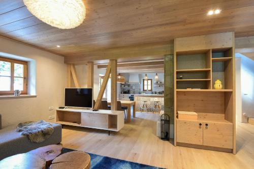 a living room with a large room with a couch and a tv at JULIAN VILLAGE LEPENA in Soča