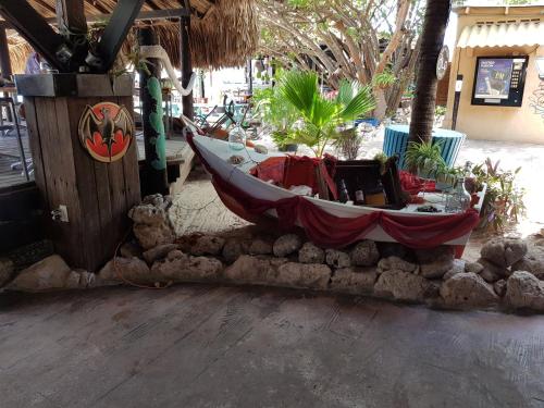 a boat sitting on a pile of rocks at Fabulous Ocean View Apartment in Secure Resort, 5 min Walk to Beaches & Restaurants in Willemstad