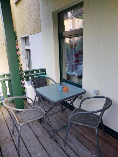 einen blauen Tisch und zwei Stühle auf dem Balkon in der Unterkunft Ferienwohnung Eddi in Reichenbach im Vogtland