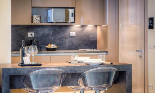 a kitchen with two chairs and a counter top at Forte16 View & SPA in Florence