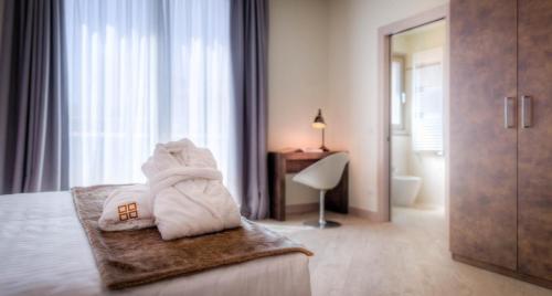 a hotel room with a bed with towels on it at Forte16 View & SPA in Florence