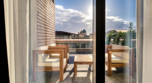 a balcony with chairs and a view of a city at Forte16 View & SPA in Florence
