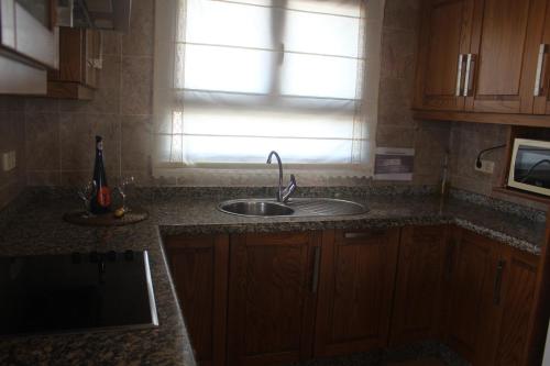 a kitchen counter with a sink and a window at VILLA RAQUEL in Yaiza