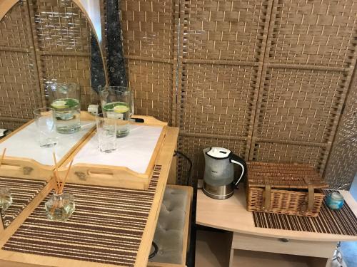 a room with a table with glasses on it at Cosy room in London Wembley in London