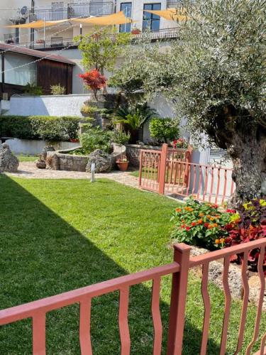a wooden fence in a yard with a garden at Hotel PINO LORICATO in Castelluccio Inferiore
